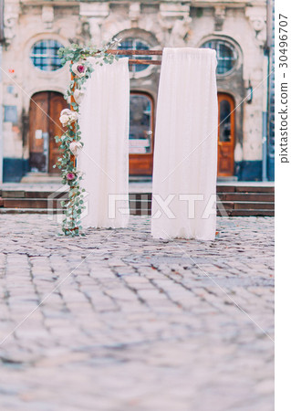 Vintage wedding arch with flowers in the ancient 30496707