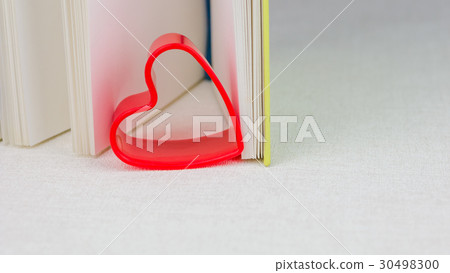 Red heart between pages of an open diary book Red heart between pages of an open diary book 30498300