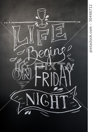 Chalk hand-drawn lettering. Life begins on friday 30498712