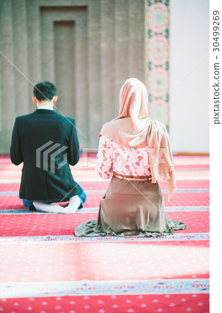 Muslim man and woman praying 30499269