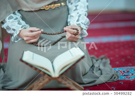 muslim woman praying in mosque muslim woman praying in mosque 30499282