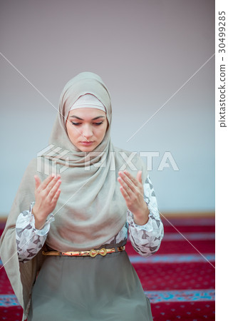 muslim woman praying in mosque muslim woman praying in mosque 30499285