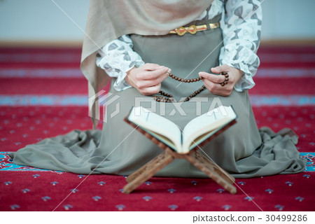 muslim woman praying in mosque 30499286