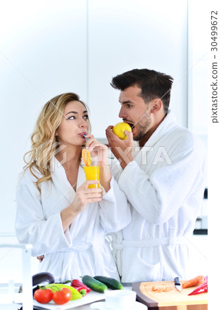 Happy couple cooking breakfast together in the 30499672
