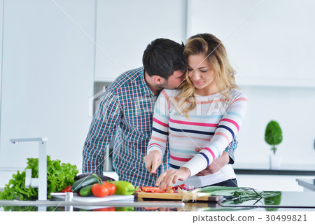 couple cooking healthy food in kitchen lifestyle 30499821