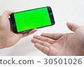 Male hand holding cell phone on white background  30501026