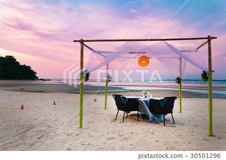 A romantic luxury dinner table setting at beach A romantic luxury dinner table setting at beach 30501296