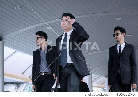 Asian business man with group of bodyguard Asian business man with group of bodyguard 30503279
