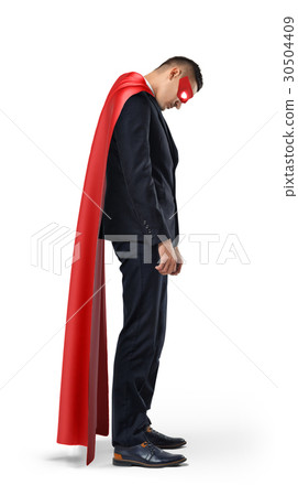 A sad businessman in a superhero red cape standing 30504409