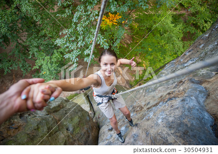 Female climber on high rock wall 30504931