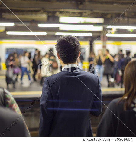 Passengers traveling by Tokyo metro. 30509694