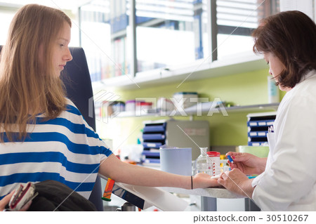 Nurse and blood donor at donation. 30510267
