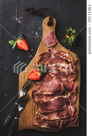 Turkish pastirma with strawberry on wooden board Turkish pastirma with strawberry on wooden board 30511961