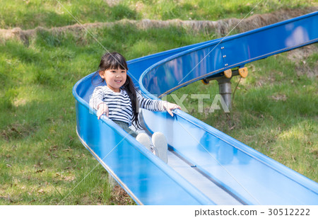 Girl playing on the slide 30512222