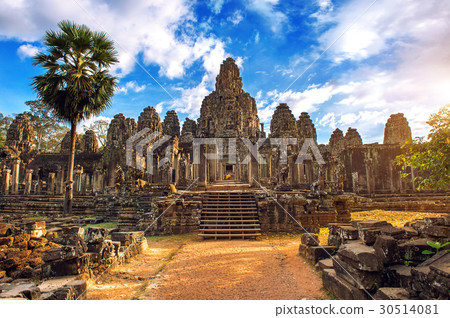 Ancient stone faces at sunset of Bayon temple. Ancient stone faces at sunset of Bayon temple. 30514081
