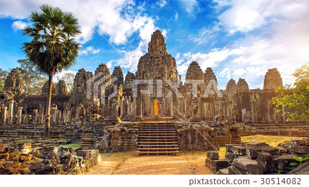 Ancient stone faces at sunset of Bayon temple. Ancient stone faces at sunset of Bayon temple. 30514082