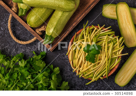 Raw zucchini pasta on dark background. Raw zucchini pasta on dark background. 30514898