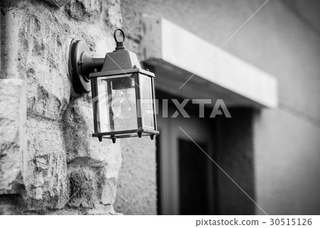 Old iron street lantern on a brick wall in BW 30515126