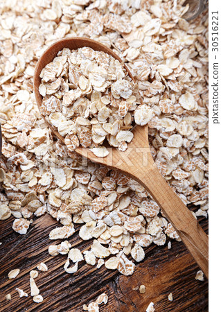 Scattered oatmeal in a wooden spoon 30516221