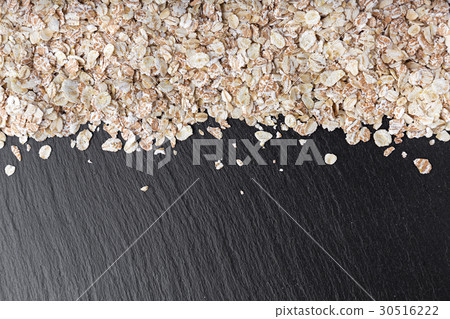 raw oatmeal is scattered 30516222