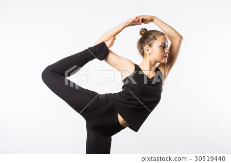 Attractive Woman doing Standing Bow Yoga Pose Attractive Woman doing Standing Bow Yoga Pose 30519440