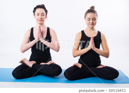 Young man and woman doing yoga and meditating in Young man and woman doing yoga and meditating in 30519451