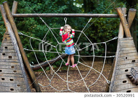 Child having fun on school yard playground 30520991