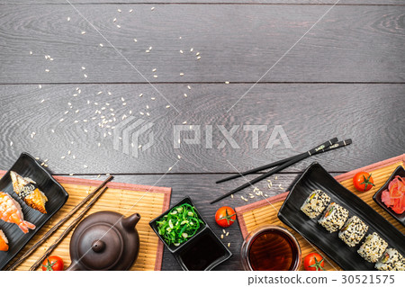 Sushi set sashimi and sushi rolls and tomatoes 30521575