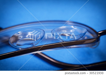 Two soft contact lenses lie on the lens 30521930