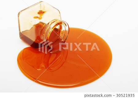 Honey spill from a glass jar 30521935
