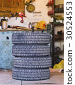 four old tires in a garage 30524553
