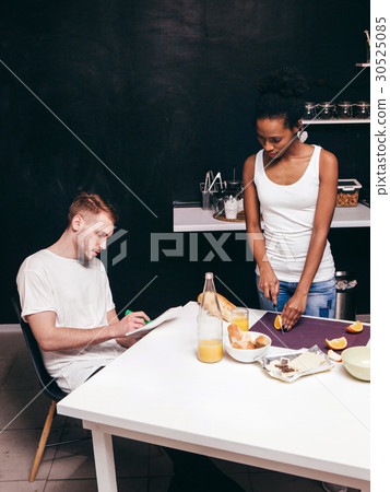 Young interracial family on kitchen. Cook together 30525085