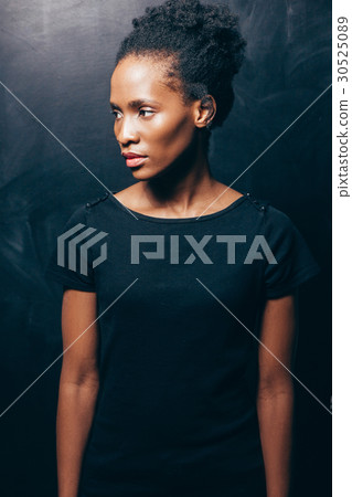 Pretty afroamerican woman on dark background Pretty afroamerican woman on dark background 30525089