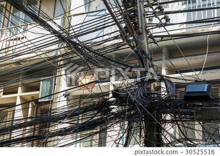 Chaos of cables and wires on electric pole 30525516
