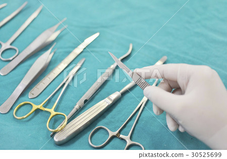 Hand holding surgical instruments Hand holding surgical instruments 30525699