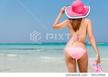 Hot beautiful woman in sunhat and bikini standing 30528994
