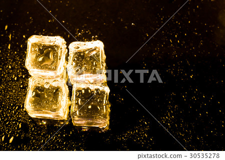 ice cubes and water drop on light golden. 30535278