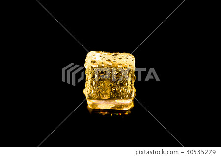 ice cubes and water drop on light golden. 30535279