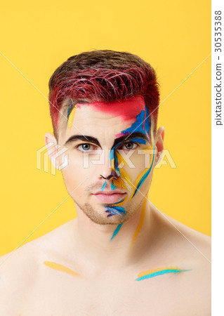 portrait of young man with colored face paint on 30535388