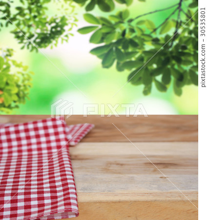 checkered tablecloth and blur leaves background checkered tablecloth and blur leaves background 30535801