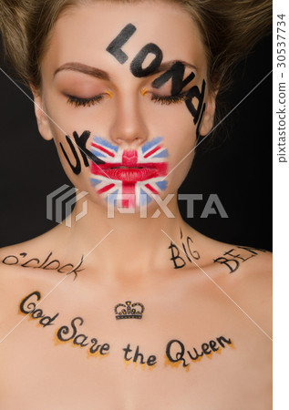 Young woman with english symbols on her face Young woman with english symbols on her face 30537734