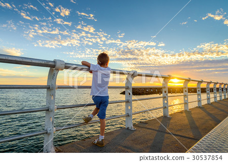Boy watching sunset from St. Kilda Jetty Boy watching sunset from St. Kilda Jetty 30537854