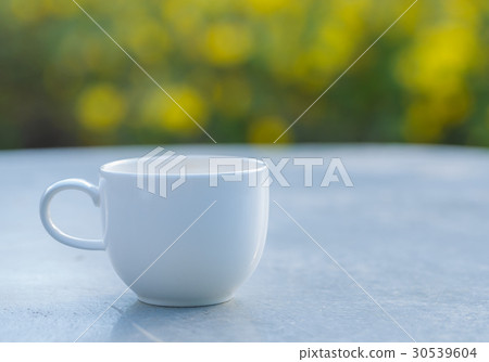 cup of coffee on table in green garden cup of coffee on table in green garden 30539604