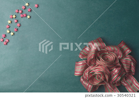 Decorative red and gree ribbon on old green board 30540321