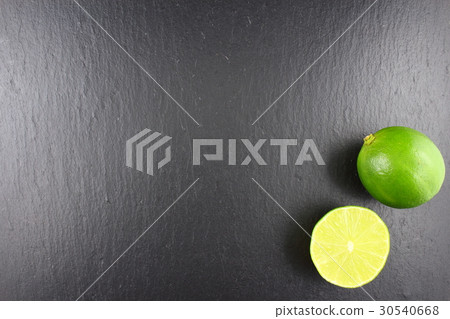 fresh lime fruit on a slate plate 30540668
