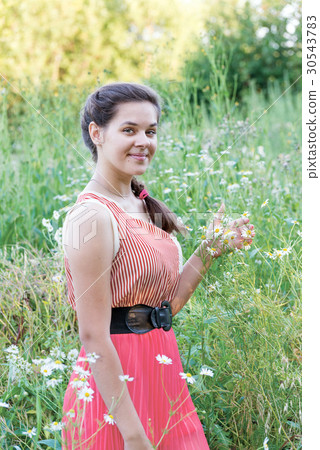 Portrait of girl in a chamomile field 30543783