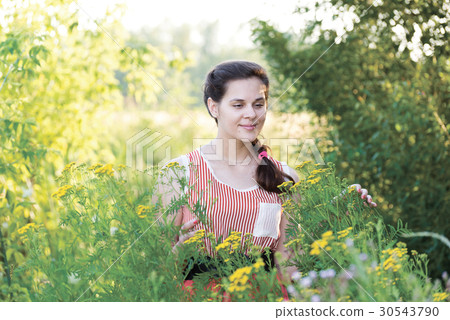 Beautiful Russian girl in thickets of tansy Beautiful Russian girl in thickets of tansy 30543790