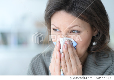 Cold young woman with a handkerchief 30543877