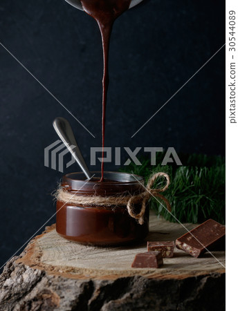 Homemade dark hot chocolate in a glass jar. Dark Homemade dark hot chocolate in a glass jar. Dark 30544089