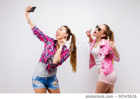 Fashion portrait of two friends posing. modern Fashion portrait of two friends posing. modern 30545626